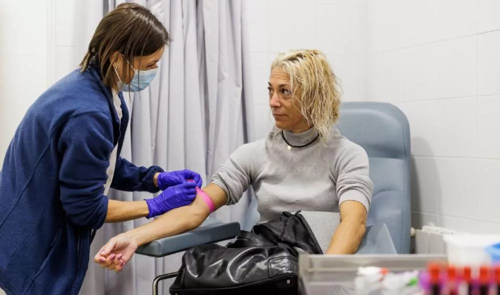 Enfermera sacando sangre a una paciente