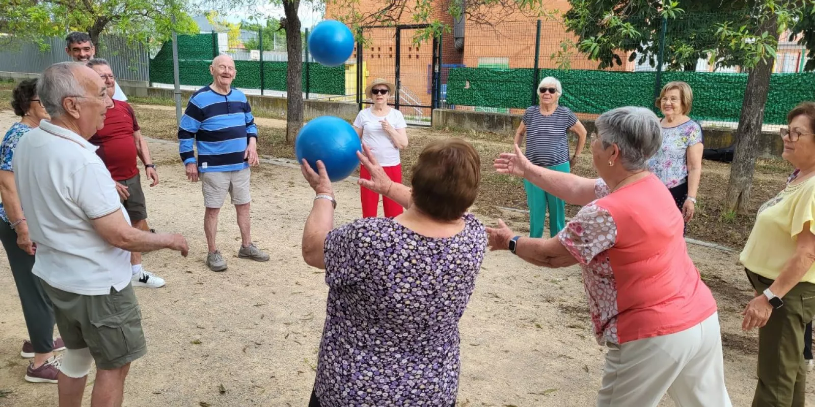Grup de persones participen un una activitat comunitària a l'exterior impulsada des de l'equip d'atenció primària de Salt