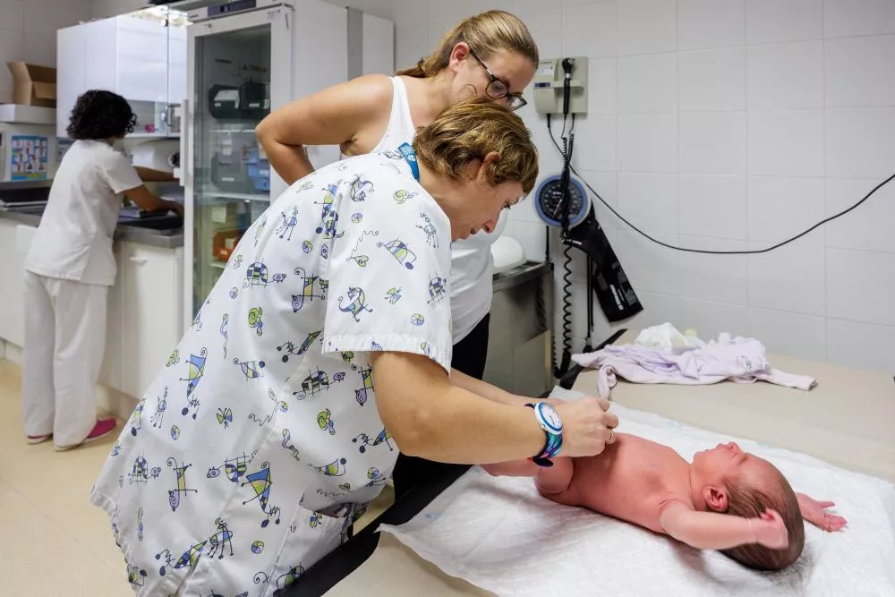 Médico visitando a un bebe recién nacido
