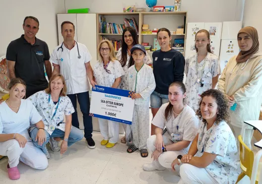 El director de Sea Otter Europe i la ciclista Txell Figueras visiten els professionals de la planta de pediatria del Trueta per fer entrega del xec solidari.